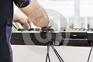 The arms of a dj playing with music