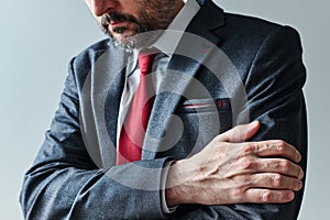 Arms gripping, restrained insecure businessman waiting for bad news