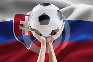 Arms holding ball with flag of Slovakia