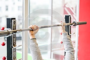 Arms of man working out in the gym, beginner athlete doing bench press exercise