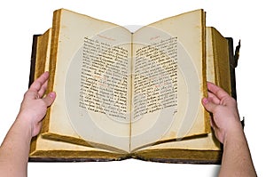 Arms are turn over the pages of opened old book