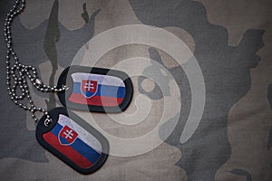 Army blank, dog tag with flag of slovakia on the khaki texture background.