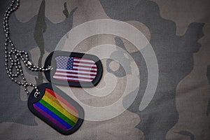 army blank, dog tag with flag of united states of america and gay rainbow flag on the khaki texture background.