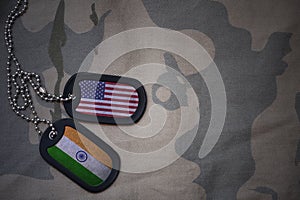 army blank, dog tag with flag of united states of america and india on the khaki texture background