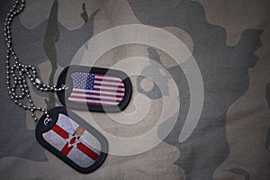 army blank, dog tag with flag of united states of america and northern ireland on the khaki texture background.