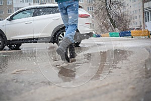 In army boots in puddles, black lace-up boots and wet weather, trekking shoes in the city