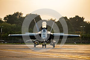 Army fighter airplane with open cockpit. Military navy pilot waving after landing in beautiful sunset light