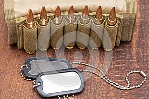 Army identification medallions, bandolier with cartridges, Concept: military special operation, sniper work in war, financing of w