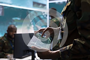 Army intelligence specialists using advanced computer systems and satellite data