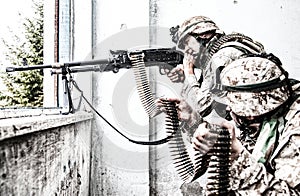 Army machine gunner attacks enemy with aimed fire