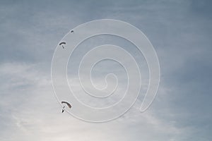 Army Parachute team sailing through a blue sky