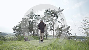 Army soldier removes mines, sapper with examines territory, minesweeper uses a mine detector, outdoors