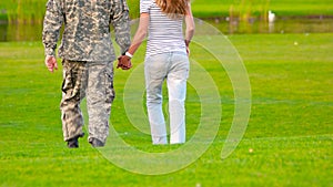 Army soldier reunited with wife, close up.