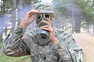 Army soldier wearing gas mask in nature