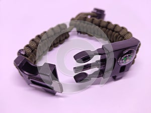 Army style wristband containing compass and fire initiator