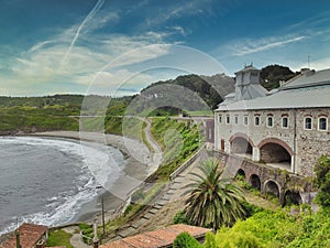 Arnao beach and ancient coal mine building, Castrillon, Asturias, Spain photo