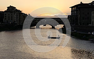 Arno river with Ponte Vecchio, `Old Bridge`, sunset view, Florence, Italy