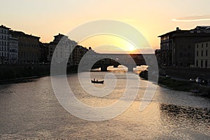 Arno river with Ponte Vecchio, `Old Bridge`, sunset view, Florence, Italy