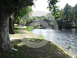 Arnoia River and roman bridge by the forest in Allariz photo