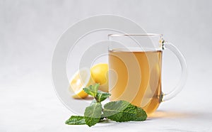 Aroma a cup of lemon tea with mint on a light background. The concept of a healthy breakfast drink for .immunity and vigor