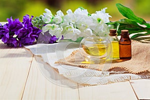 aroma essential oil or spa and natural fragrance oil with flower on wooden table