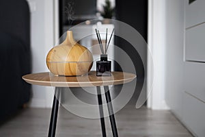 Aroma oil diffuser on table at home. Air freshener