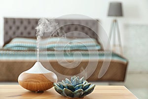 Aroma oil diffuser on table at home photo