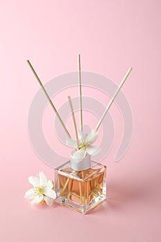 Aroma scent diffuser and flowers on pink background