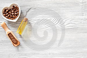 Aroma spa set. Coffee grains, coffee spa salt, oil on wooden table background top view copyspace