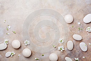 Aromatherapy, beauty and spa background with pebble and candles decorated white flowers. Relaxation and zen like concept. Top view