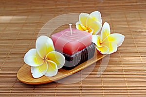 Aromatherapy candle with fresh frangipani flower