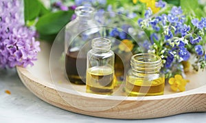 Aromatherapy. Natural medicinal plants and herbs oil bottles, natural floral extracts and oils, natural oils photo