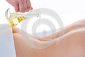 Aromatherapy oil massage. Masseur doing aromatherapy oil massage