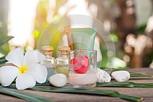 Aromatherapy product spa of therapy massage with plumeria or frangipani flowers, stones, aroma candle and oil on the desk,Spa