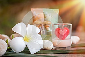 Aromatherapy product spa of therapy massage with plumeria or frangipani flowers, stones, aroma candle and oil on the desk,Spa