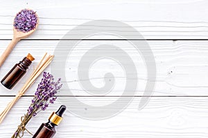 Aromatherapy for relax concept. Lavender branch, spa salt and oil on white wooden background top view copyspace