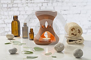 Aromatherapy votive candles burning in essential oil diffuser for wellness treatment in spa