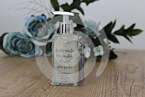 Aromatic air freshener in a transparent glass bottle with mantra