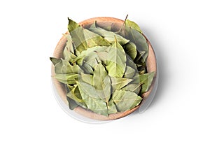 Aromatic bay leaves in wooden bowl on white background, top view