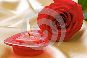 Aromatic candle and red rose photo