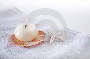Aromatic candle with seashells in the the spa