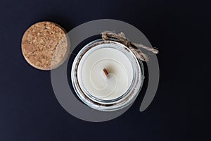 aromatic candle with a wooden wick in a glass candlestick