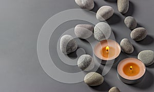 Aromatic  candles  and stones on a gray background. Spa composition. Relaxation and zen like concept. Flat lay. Copy space