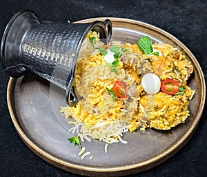 Aromatic Chicken Biryani Spilling from Black Container
