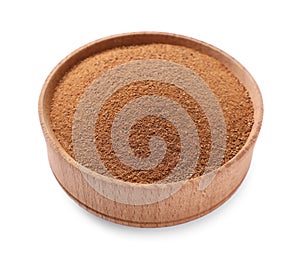 Aromatic cinnamon powder in wooden bowl on white background