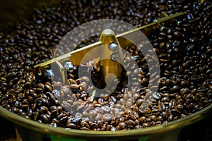 Coffee beans roasted in coffee roasters machine photo