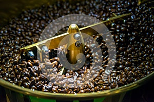 Coffee beans roasted in coffee roasters machine photo