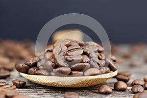 aromatic coffee beans in a wooden spoon