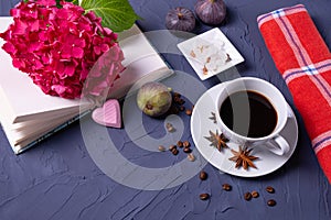 Aromatic coffee, coffee beans and sugar cubes, an open book and a hydrangea branch