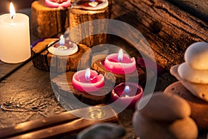 Lighted candles with ornate wood and scented and energetic incense photo